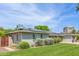 Landscaped front yard featuring lush green grass and mature plants at 4208 E Windsor Ave, Phoenix, AZ 85008