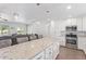 Open kitchen with stainless steel appliances, granite countertops, island, and a seamless view into the living area at 4208 E Windsor Ave, Phoenix, AZ 85008