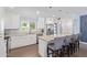 Bright kitchen features granite countertops, stainless steel appliances, island with bar seating, and ample cabinet space at 4208 E Windsor Ave, Phoenix, AZ 85008