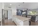 This kitchen features stainless steel appliances, granite counters, an island with bar seating, and an open layout at 4208 E Windsor Ave, Phoenix, AZ 85008
