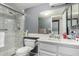 Bathroom featuring a white marble shower, matching vanity with a marble countertop, and convenient washer/dryer closet at 461 W Holmes Ave # 224, Mesa, AZ 85210