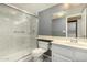 Bathroom with a white-tiled shower, toilet, vanity and mirror at 461 W Holmes Ave # 224, Mesa, AZ 85210