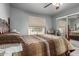 Bedroom with a four-poster bed and a view of the tennis court at 461 W Holmes Ave # 224, Mesa, AZ 85210