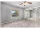 Bedroom showing neutral colored walls and soft carpeted floors, complete with window and ceiling fan at 461 W Holmes Ave # 224, Mesa, AZ 85210