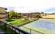 Scenic view of community amenities, including a tennis court, pool, gazebo, and lush landscaping at 461 W Holmes Ave # 224, Mesa, AZ 85210