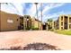 Exterior view of the community's architecture, landscape, and paved entry, inviting and well maintained at 461 W Holmes Ave # 224, Mesa, AZ 85210