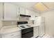 The kitchen features white cabinets, countertops, and appliances for a clean look at 461 W Holmes Ave # 224, Mesa, AZ 85210