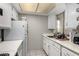 Galley kitchen with white cabinets and updated appliances at 461 W Holmes Ave # 224, Mesa, AZ 85210