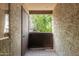 Outdoor patio with gray textured walls, ceramic tiled floors, a wooden railing and door at 461 W Holmes Ave # 224, Mesa, AZ 85210