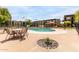 Community pool with lounge area and cabana, enhanced landscaping, all surrounded by well-maintained apartment buildings at 461 W Holmes Ave # 224, Mesa, AZ 85210