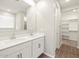 Bright bathroom showcasing a double sink vanity, a large mirror, and a walk-in closet at 4813 N 177Th Ln, Goodyear, AZ 85395