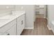 Bathroom featuring double sinks, wood-look tile flooring, and a walk-in closet for ample storage at 4813 N 177Th Ln, Goodyear, AZ 85395