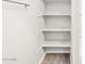 A storage closet complete with shelves is conveniently located in a bright, well-organized bathroom space at 4813 N 177Th Ln, Goodyear, AZ 85395