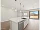 Bright kitchen with white island, stainless steel appliances and modern lighting at 4813 N 177Th Ln, Goodyear, AZ 85395