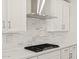 Modern kitchen with stainless steel range hood and mosaic backsplash at 4813 N 177Th Ln, Goodyear, AZ 85395