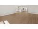 Open-concept living space with wood-style tile flooring and a view of the kitchen at 4813 N 177Th Ln, Goodyear, AZ 85395