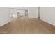 Large living area with wood-style tile flooring, open to the kitchen and dining at 4813 N 177Th Ln, Goodyear, AZ 85395