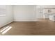 Spacious living room featuring wood-style tile flooring, open to the kitchen at 4813 N 177Th Ln, Goodyear, AZ 85395