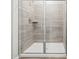 Modern shower featuring gray tile and a glass door, offering a spa-like experience at 4813 N 177Th Ln, Goodyear, AZ 85395