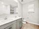 Bright bathroom with double vanity, gray cabinets, and wood-look tile floors at 4819 N 177Th Ln, Goodyear, AZ 85395