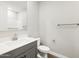 Modern bathroom with gray cabinets, double sinks, and well-lit vanity area at 4819 N 177Th Ln, Goodyear, AZ 85395