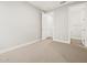 Bright bedroom featuring neutral carpet, white trim, and open doorway to bathroom at 4819 N 177Th Ln, Goodyear, AZ 85395