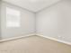 Neutral bedroom with plush carpeting, white trim, and bright natural light at 4819 N 177Th Ln, Goodyear, AZ 85395