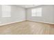 Neutral bedroom with plank flooring, two windows, and neutral walls at 4819 N 177Th Ln, Goodyear, AZ 85395