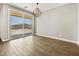 Bright dining area with wood-look tile flooring and sliding glass door to the backyard at 4819 N 177Th Ln, Goodyear, AZ 85395