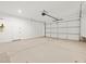Spacious garage with a neutral painted interior, concrete floor, and large overhead door at 4819 N 177Th Ln, Goodyear, AZ 85395