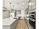 Spacious kitchen featuring modern appliances, a center island, and grey cabinets at 4819 N 177Th Ln, Goodyear, AZ 85395