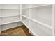 Spacious walk-in pantry features custom shelving and wood-look floors at 4819 N 177Th Ln, Goodyear, AZ 85395