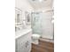Bright bathroom with a glass-enclosed shower and a white vanity with modern fixtures at 665 W Beechnut Dr, Chandler, AZ 85248