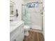 Modern bathroom featuring a glass shower, marble tile, and a sleek vanity at 665 W Beechnut Dr, Chandler, AZ 85248
