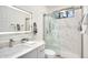Modern bathroom featuring a glass shower, marble tile, and a sleek vanity at 665 W Beechnut Dr, Chandler, AZ 85248