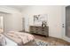 Spacious bedroom with wood floors, dresser with modern artwork, and doorway access to outdoor space at 665 W Beechnut Dr, Chandler, AZ 85248