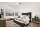 Comfortable bedroom with soft bedding, a tufted headboard, and two bedside tables with lamps at 665 W Beechnut Dr, Chandler, AZ 85248