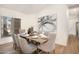 Formal dining room with a wooden table set for eight, complemented by a modern art piece at 665 W Beechnut Dr, Chandler, AZ 85248