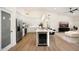 Modern kitchen with white cabinetry, stainless steel appliances, a large island, and eat-in bar at 665 W Beechnut Dr, Chandler, AZ 85248
