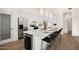 Open kitchen design with an island, plenty of seating, white cabinets, and modern stainless steel appliances at 665 W Beechnut Dr, Chandler, AZ 85248