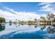 Beautiful calm lake view reflecting blue sky and clouds with luxury home in distance at 665 W Beechnut Dr, Chandler, AZ 85248