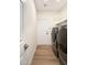 Efficient laundry room with modern washer and dryer, shelving, and neutral flooring at 665 W Beechnut Dr, Chandler, AZ 85248