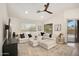 Bright living room with a large sectional sofa, ceiling fan, and neutral decor at 665 W Beechnut Dr, Chandler, AZ 85248