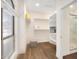 Spacious walk-in closet featuring custom shelving, wood floors, and access to the elegant bathroom at 665 W Beechnut Dr, Chandler, AZ 85248