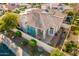 Aerial view of home, desert landscaping, tile roof, privacy wall, and covered patio at 7538 E Tuckey Ln, Scottsdale, AZ 85250