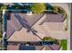 Aerial view of tile roof with solar panels, desert landscaping, and a covered patio at 7538 E Tuckey Ln, Scottsdale, AZ 85250