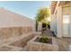 Backyard with a stone bench, planter with cacti, manicured desert landscaping, and walkway at 7538 E Tuckey Ln, Scottsdale, AZ 85250