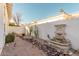 Private backyard featuring gravel landscaping, a water fountain, and privacy walls at 7538 E Tuckey Ln, Scottsdale, AZ 85250