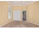 A bedroom featuring carpet, a closet, a window with shutters, and an open doorway, perfect for relaxation at 7538 E Tuckey Ln, Scottsdale, AZ 85250