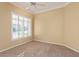 Bright bedroom with neutral walls, carpet, a ceiling fan, and plantation shutters letting in natural light at 7538 E Tuckey Ln, Scottsdale, AZ 85250